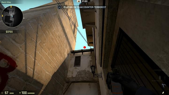 Stand in the shown spot, right next to the door and aim the grenade at the point shown in the above screenshot - Mirage | Tournament maps in CS GO - Tournament Maps in Counter Strike: Global Offensive - CS GO Game Guide