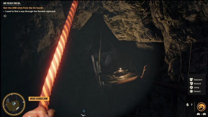At the very bottom, look up to throw the rope and reach a small ledge - Far Cry 6: And the Beat Goes On... - Treasure Hunts (Valle De Oro) - Valle De Oro - Far Cry 6 Guide