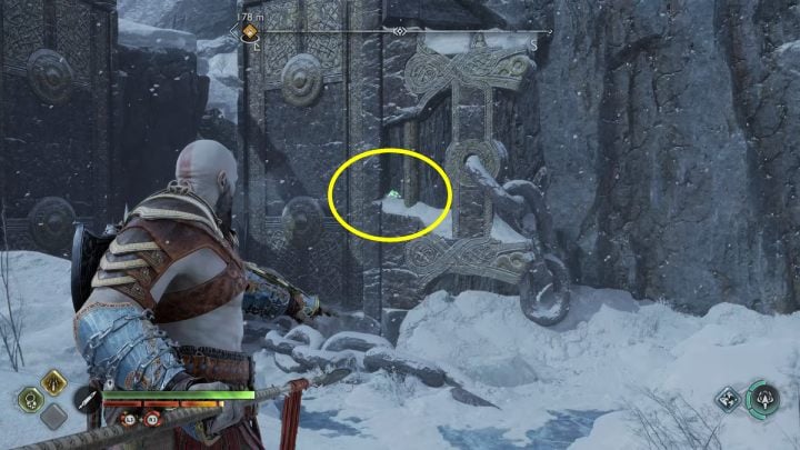 The bird is on a wall next to a large gate - God of War Ragnarok: Lake of Nine, Midgard - secrets, collectibles - God of War Ragnarok: Midgard - God of War Ragnarok Guide