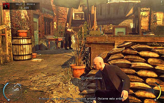 Go to the left, sneaking near sandbags, at which persons on shooting range stand - Gun Shop - Getting the key to the cabinet | 8: Birdies Gift - 8: Birdies Gift - Hitman: Absolution Game Guide