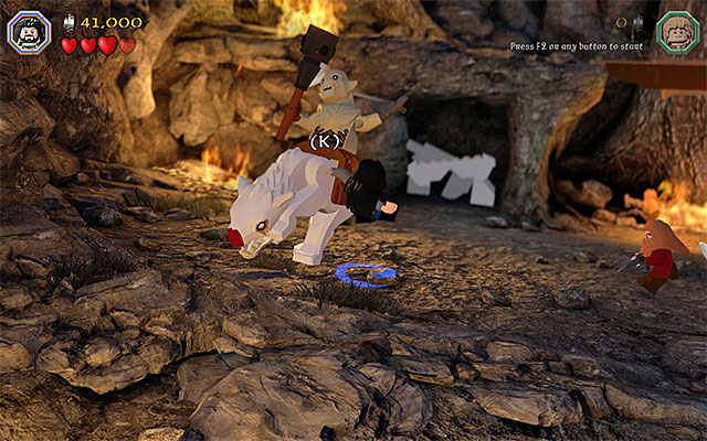 Keep pressing the indicated keys, thanks to which you will stun the bosss warg - Stage 8 (Out of the Frying Pan...): The battle with Azog the Defiler | Walkthrough - Walkthrough - LEGO The Hobbit Game Guide & Walkthrough