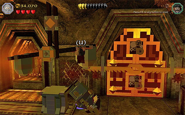 You need to grab on to the lever and remain in that position - Stage 1 (Greatest Kingdom in Middle-Earth): Inside the Lonely Mountain | Walkthrough - Walkthrough - LEGO The Hobbit Game Guide & Walkthrough