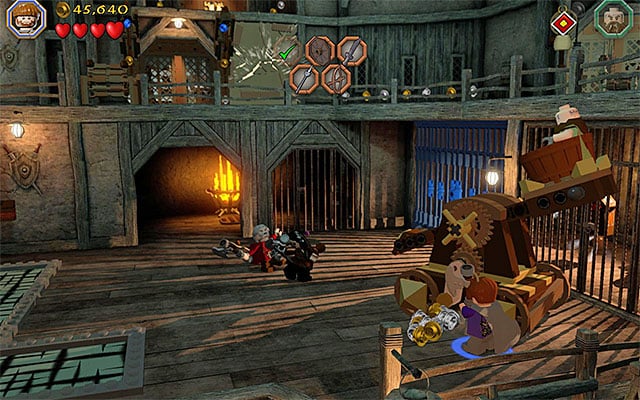 Hit the catapult, after one of the dwarves jumps in there - Stage 12 (A Warm Welcome): The armory | Walkthrough | LEGO The Hobbit - Walkthrough - LEGO The Hobbit Game Guide & Walkthrough