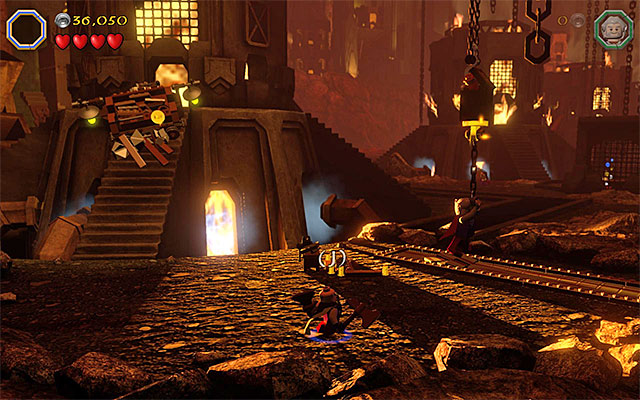 You need to attach weight to the chain, by hanging down from it with two characters - Stage 16 (Inside Information) | Main Stages - Collectibles - Main Stages - Collectibles - LEGO The Hobbit Game Guide & Walkthrough