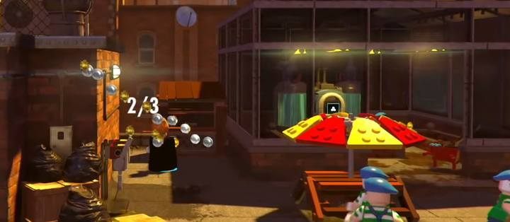 The second poster booth and a Minikit #5. - Minikits in level 7 (The Golden Years) in LEGO The Incredibles - Location of all minikits - LEGO The Incredibles Game Guide