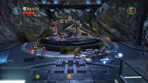 Use rockets to destroy all silver bricks near the platform with dinosaur and use remaining brick to build platform for trackball (picture) - Unwelcome Guests | Walkthrough - Walkthrough - LEGO Batman 2: DC Super Heroes Game Guide & Walkthrough