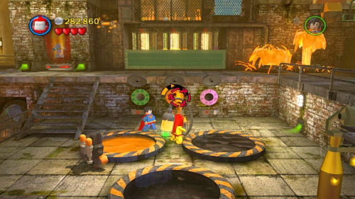 It will open three hatches on the wall at the bottom of the screen - Chemical Crisis | Walkthrough - Walkthrough - LEGO Batman 2: DC Super Heroes Game Guide & Walkthrough