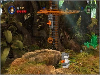 On the left side you will find a buried, golden monument head - Chapter 1 - The Lost Temple - part 1 - Riders of the Lost Ark - LEGO Indiana Jones: The Original Adventures - Game Guide and Walkthrough