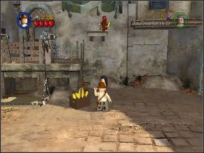 Take a banana from the basket and throw it to the monkey - Chapter 3 - City of Danger - part 1 - Riders of the Lost Ark - LEGO Indiana Jones: The Original Adventures - Game Guide and Walkthrough