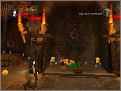 Destroy the wall to the left, take the LEGO piece and put it under the middle hole in the wall - Chapter 4 - The Well of Souls - part 1 - Riders of the Lost Ark - LEGO Indiana Jones: The Original Adventures - Game Guide and Walkthrough