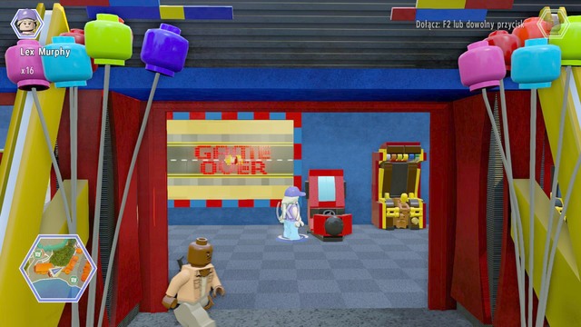 As Murphy, walk to the game zone and use the machine shown on the picture - Main Street | Jurassic World - secrets in free roam - Jurassic World - secrets in free roam - LEGO Jurassic World Game Guide & Walkthrough
