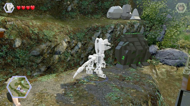 After reaching the shore, switch your character to dilophosaurus and destroy the rock that blocks access to the cave - Erics Hideout | Jurassic Park III - secrets in free roam - Jurassic Park III - secrets in free roam - LEGO Jurassic World Game Guide & Walkthrough