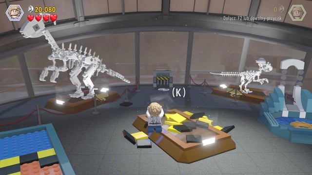 Use the scattered bricks to build an arm with a hammer and smash the glass pane with the velociraptor - Main Street Showdown | Jurassic World - walkthrough - Jurassic World - walkthrough - LEGO Jurassic World Game Guide & Walkthrough