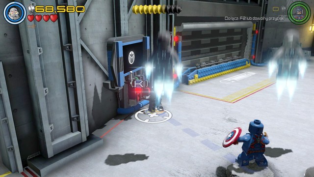 After fixing the vehicle in the middle of the garage you will unlock the possibility to activate the console shown on the picture - Minikits - A Loki Entrance - secrets - LEGO Marvels Avengers - Game Guide and Walkthrough