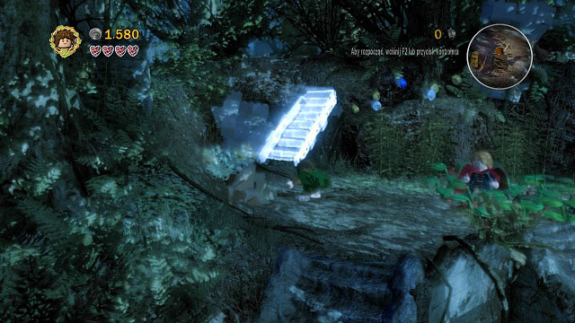 After breaking the boulder, you will receive a small rock which you can throw at the stone hand in the background - Amon Hen - Walkthrough - Act I - LEGO The Lord of the Rings - Game Guide and Walkthrough