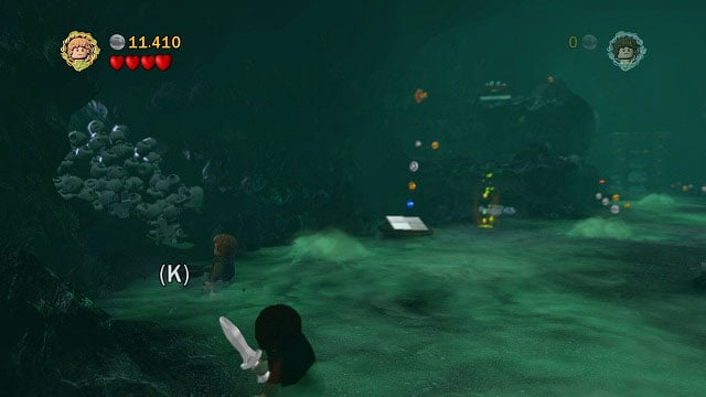 In the second big cave, on the left side there is some loose ground beside a pile of skulls - The Paths of the Dead - Collectibles - LEGO The Lord of the Rings - Game Guide and Walkthrough