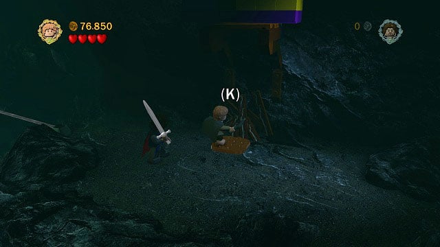 Push the pillar and head onto the right rock ledge to see a campfire place - The Paths of the Dead - Collectibles - LEGO The Lord of the Rings - Game Guide and Walkthrough