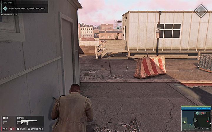 Once you enter the enemy territory, first pass through the large building in which the cars are fixed - Auto Theft (car stealing racket) | Walkthrough - Story missions - Mafia III Game Guide