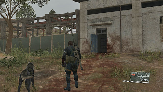 The entrance to the main building in the Industrial Zone. - Locating Shabani | Walkthrough - Mission 20 - Voices - Metal Gear Solid V: The Phantom Pain Game Guide & Walkthrough
