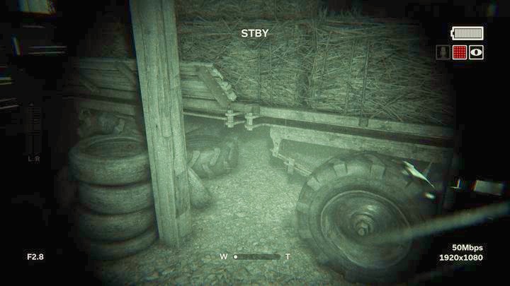 First, walk around the trailer with hay to the right and hide underneath it - The Fields | Genesis | Walkthrough - Genesis - Outlast 2 Game Guide