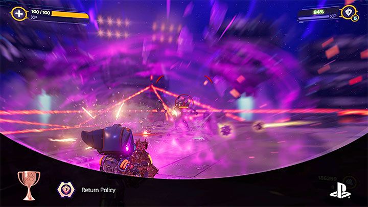 You can deflect the collected projectiles by pressing R2 all the way down - Ratchet & Clank Rift Apart: Trophies - List - Appendix - Ratchet & Clank Rift Apart Guide