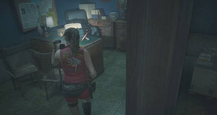 The round handle is on the desk in the smaller office. - Meet with the visitor (cutting tool) task | Police station in Resident Evil 2 - Walkthrough - Resident Evil 2 Guide