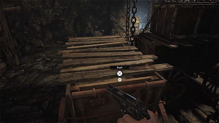 Push the first cart to the side and the second one down - Resident Evil Village: Necklace with Two Holes - how to complete? - Puzzle solutions - Resident Evil Village Guide