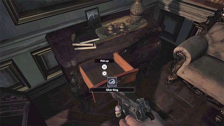 In the Hall of Pleasure, have a look inside the desk drawer to find the ring - Resident Evil Village: Silver Ring and Azure Eye - how to find and combine them? - FAQ - Resident Evil Village Guide