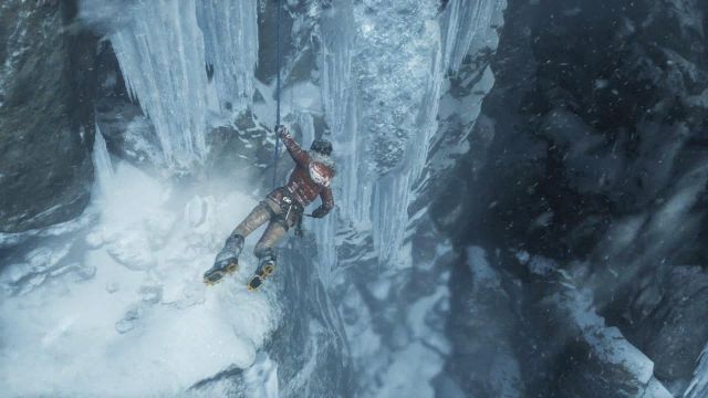 Lara is hanging on the rope - Rise of the Tomb Raider: Get to the top of the mountain walkthrough - Siberian Wilderness - Passageway - Rise of the Tomb Raider Guide