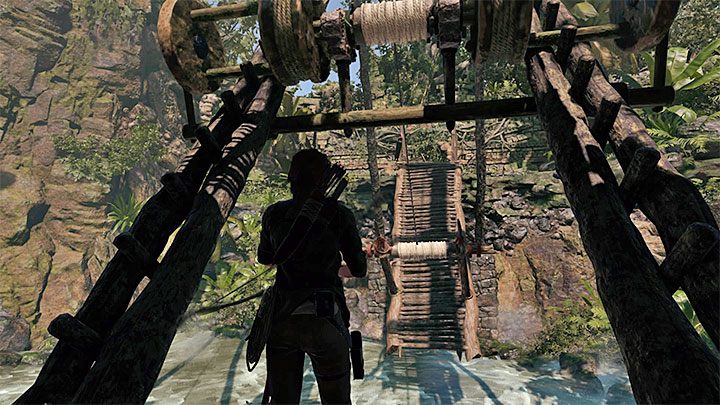 Aim the bow at the rope coil shown on picture 1 - How to solve the bridge riddle in Shadow of the Tomb Raider Game? - Solving Riddles - Shadow of the Tomb Raider Game Guide