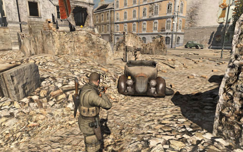 On the right light of the car [#5] which you pass by on the left while going to the next building - Mission 1 | Wine Bottles and Gold Bars - Wine Bottles and Gold Bars - Sniper Elite V2 Game Guide & Walkthrough