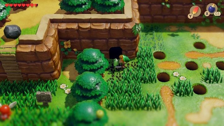 Move left a bit, avoid holes in the ground and place a bomb next to another cracked wall by the tree - Anglers Tunnel | Links Awakening Walkthrough - Walkthrough - Links Awakening Guide