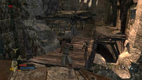 Destroy all the crates and barrels around, and then move closer to the war machine and begin to quickly press the use/inspect button - Battlements - Chapter 1 - The Lord of the Rings: War in the North - Game Guide and Walkthrough